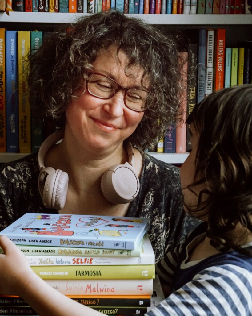 Magda Majewska trzymająca książki dla dzieci